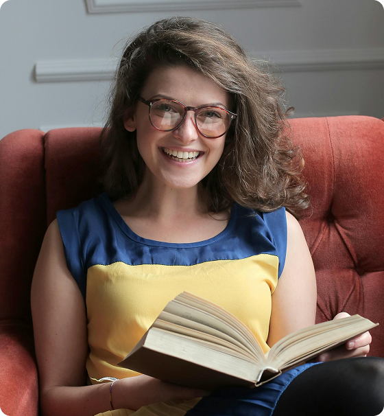 Smiling woman reading outdoors, the kind of match Keeper users aim to attract